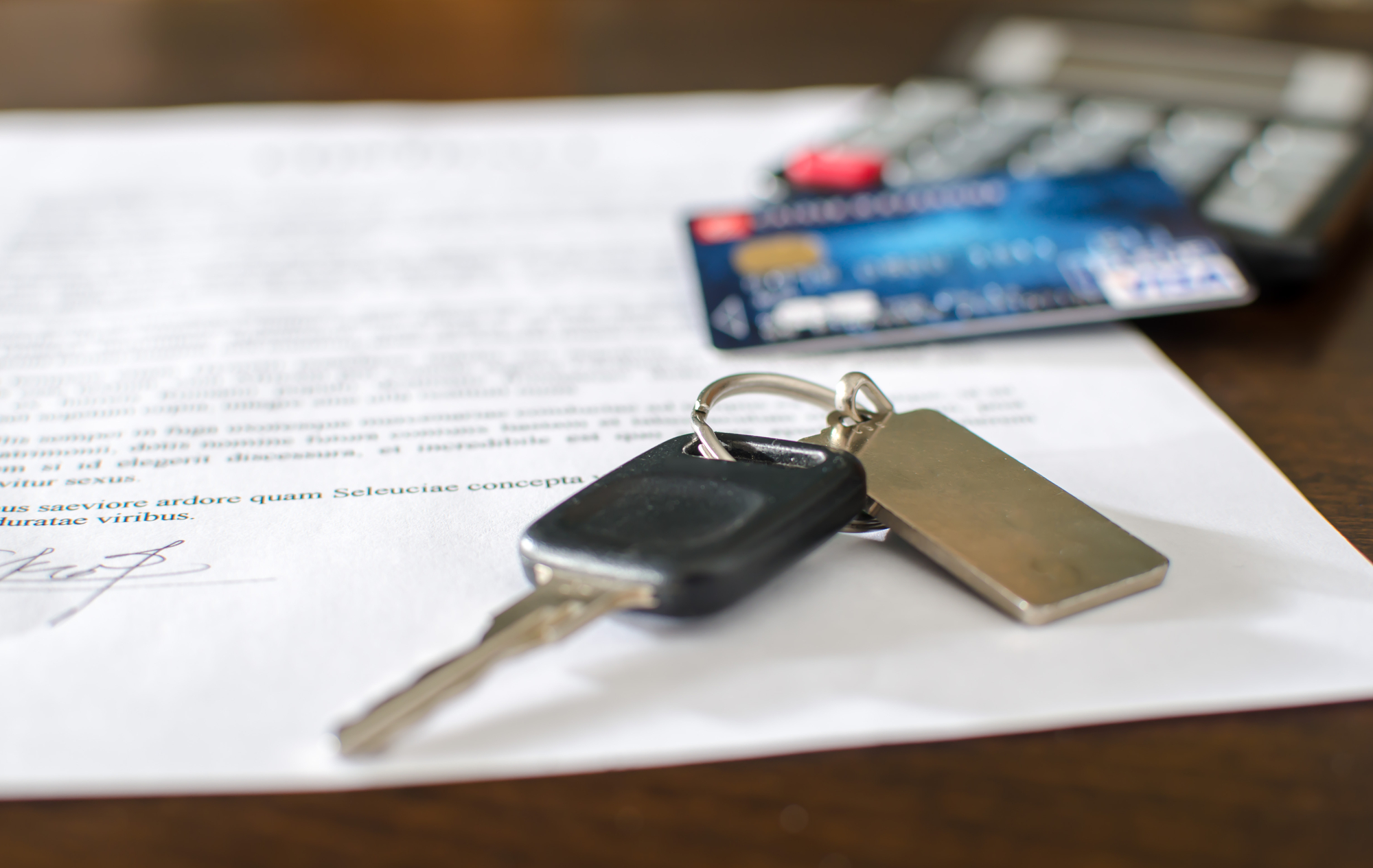 Car key & credit card on a signed contract