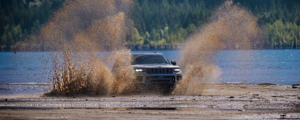 2025 Jeep Grand Cherokee driving through muddy water 2025 Jeep Grand Cherokee driving through muddy water