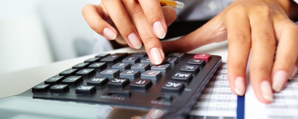 Hands Doing Calculations with Calculator - Finance Hands Doing Calculations with Calculator