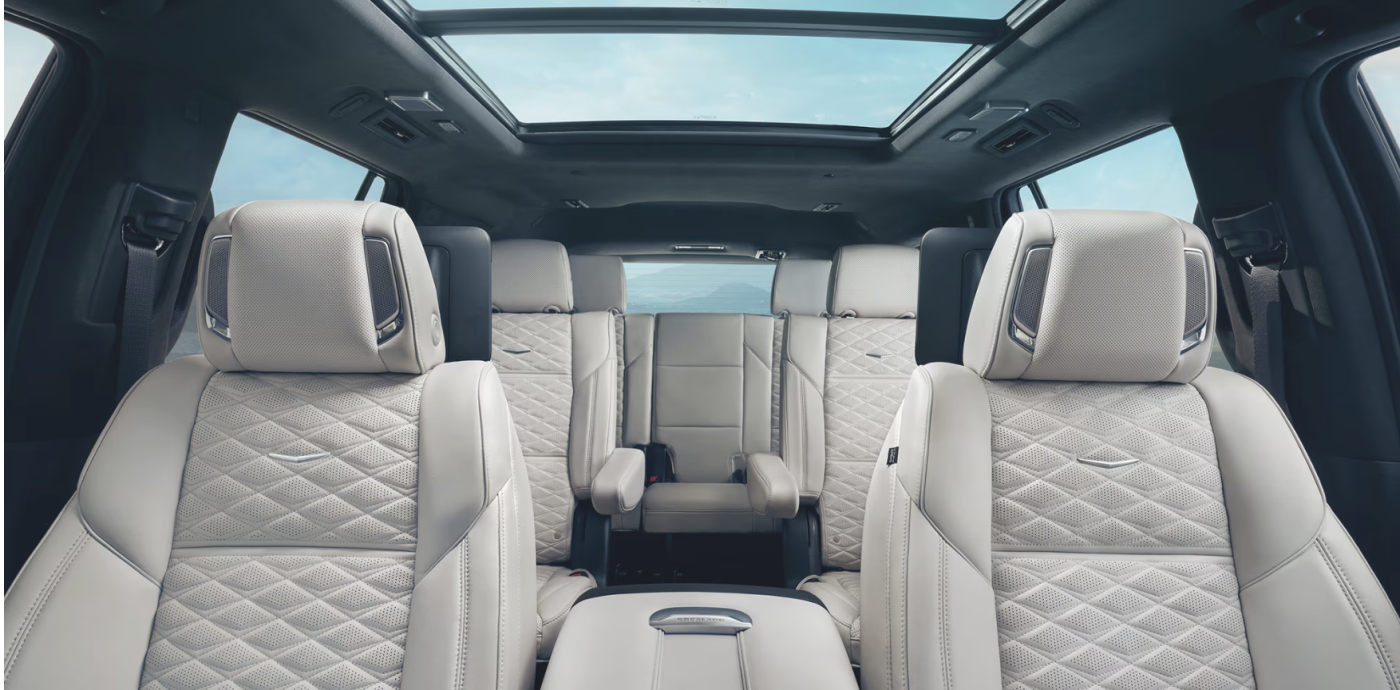 The interior of the Cadillac Escalade is showing the white seating. 