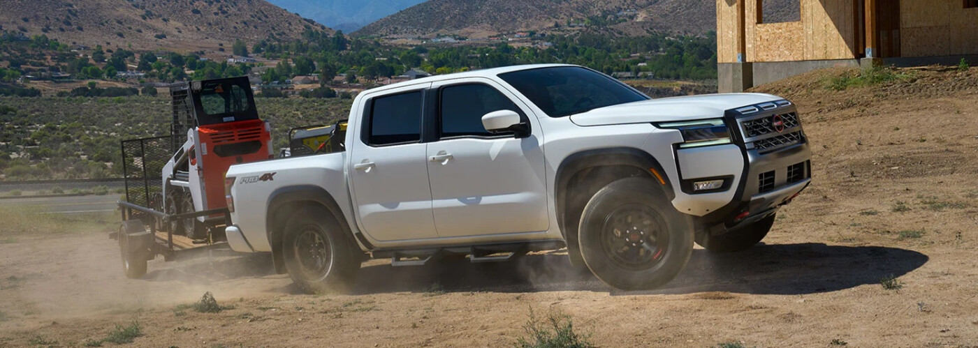 2026 White Nissan Frontier towing 