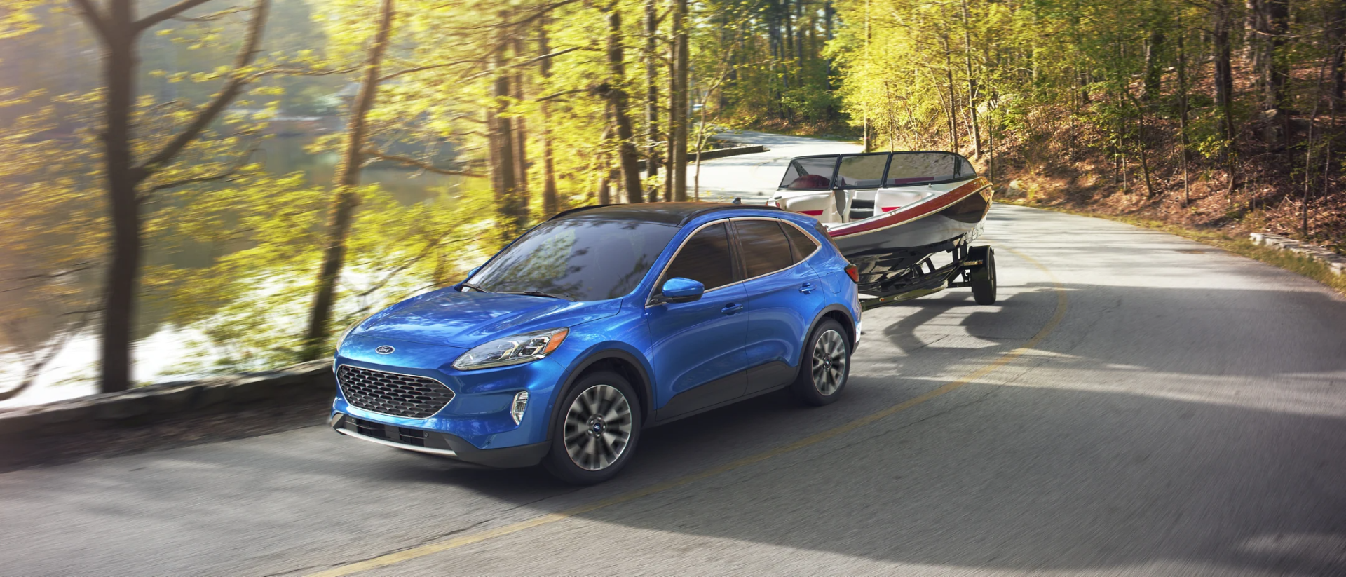 Blue 2021 Ford Escape towing a boat