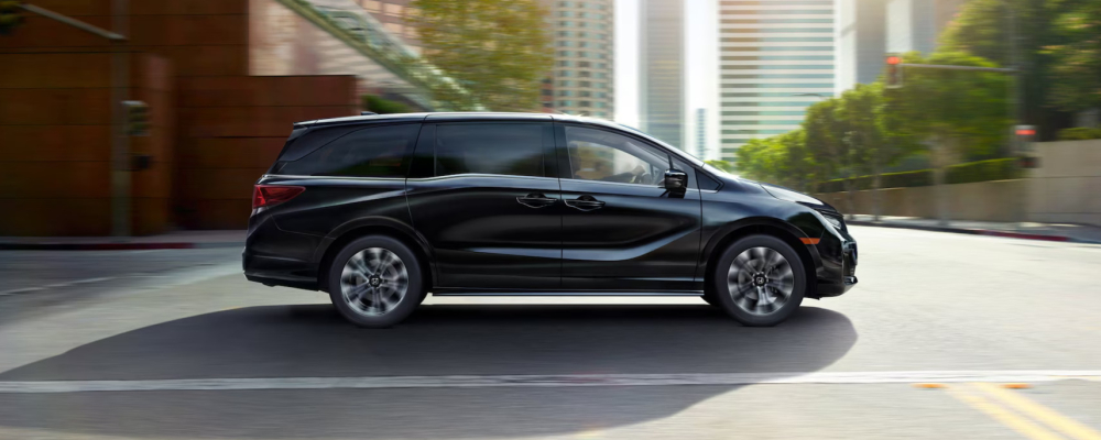 2026 Honda Odyssey driving down a city street