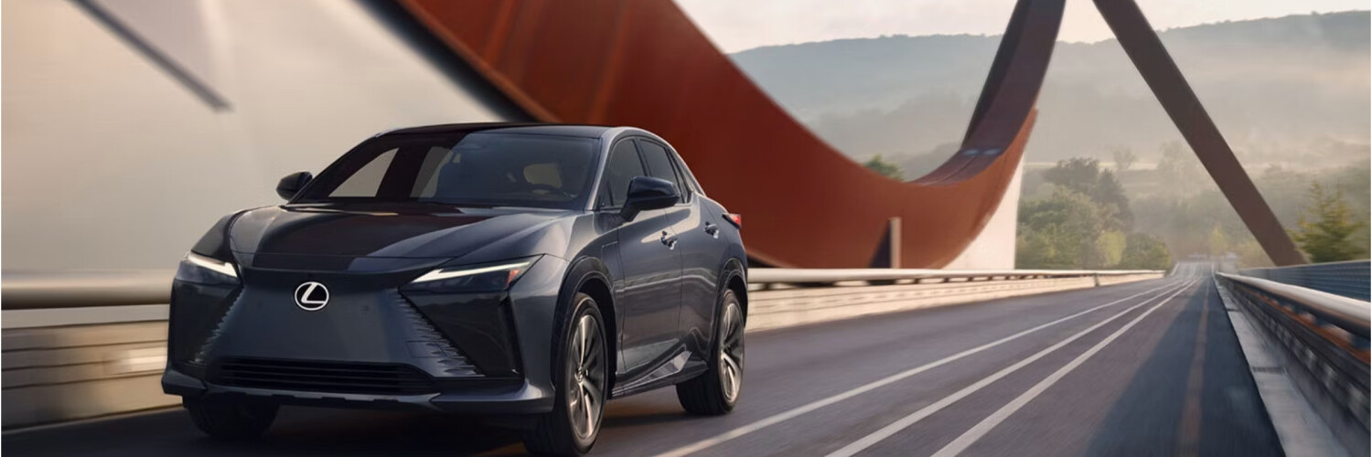 2025 Lexus RZ 2025 Lexus RZ driving with bridge in background