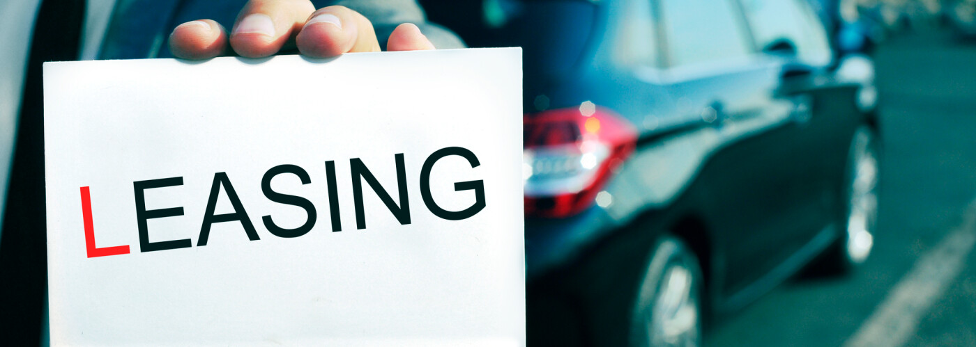 The man is holding a leasing sign. 