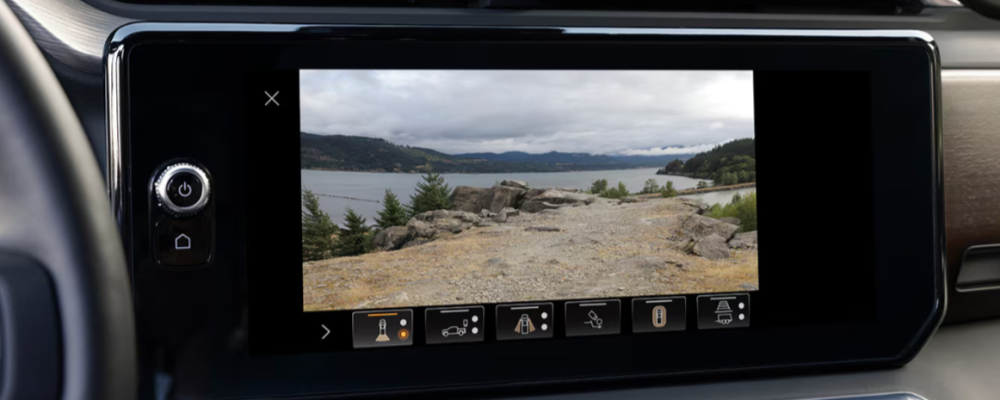 The navigation screen on the dash is showing a mountain scene.