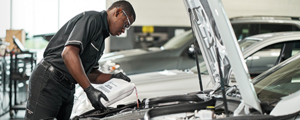 Mercedes-Benz technician servicing a vehicle