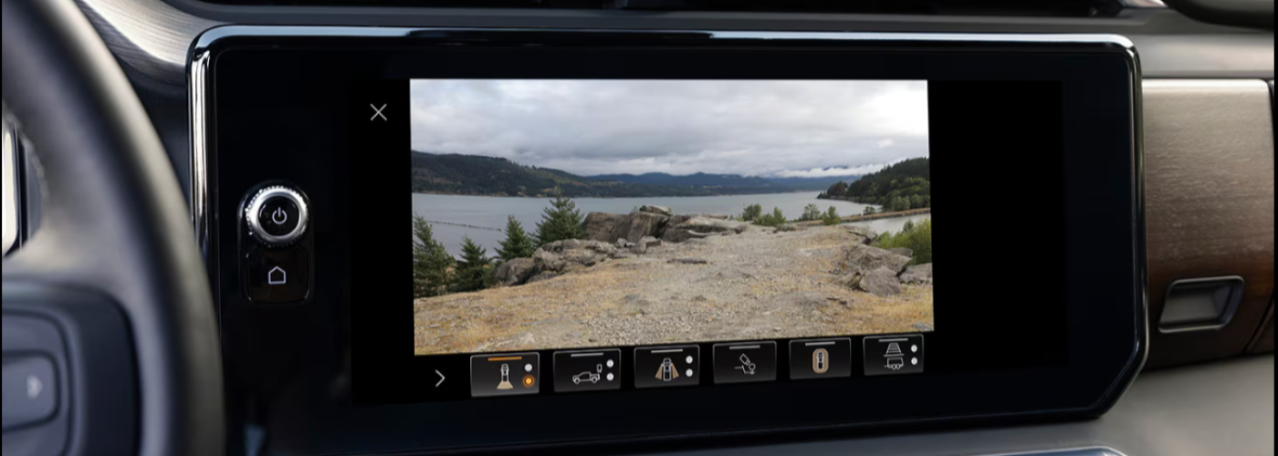 The navigation screen on the dash is showing a mountain scene.