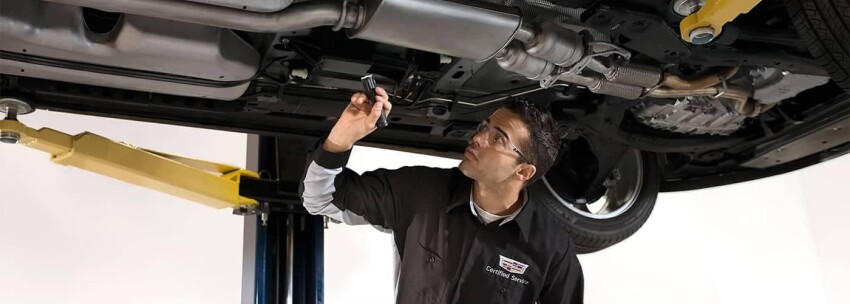 Cadillac Service Technician Inspecting under vehicle