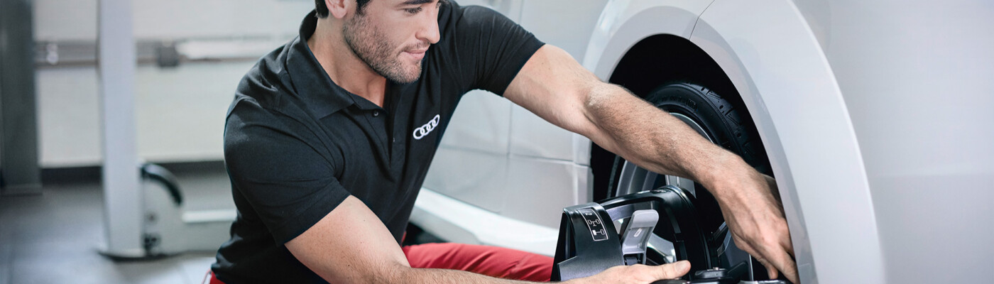 Audi Mechanic replacing Audi part on car
