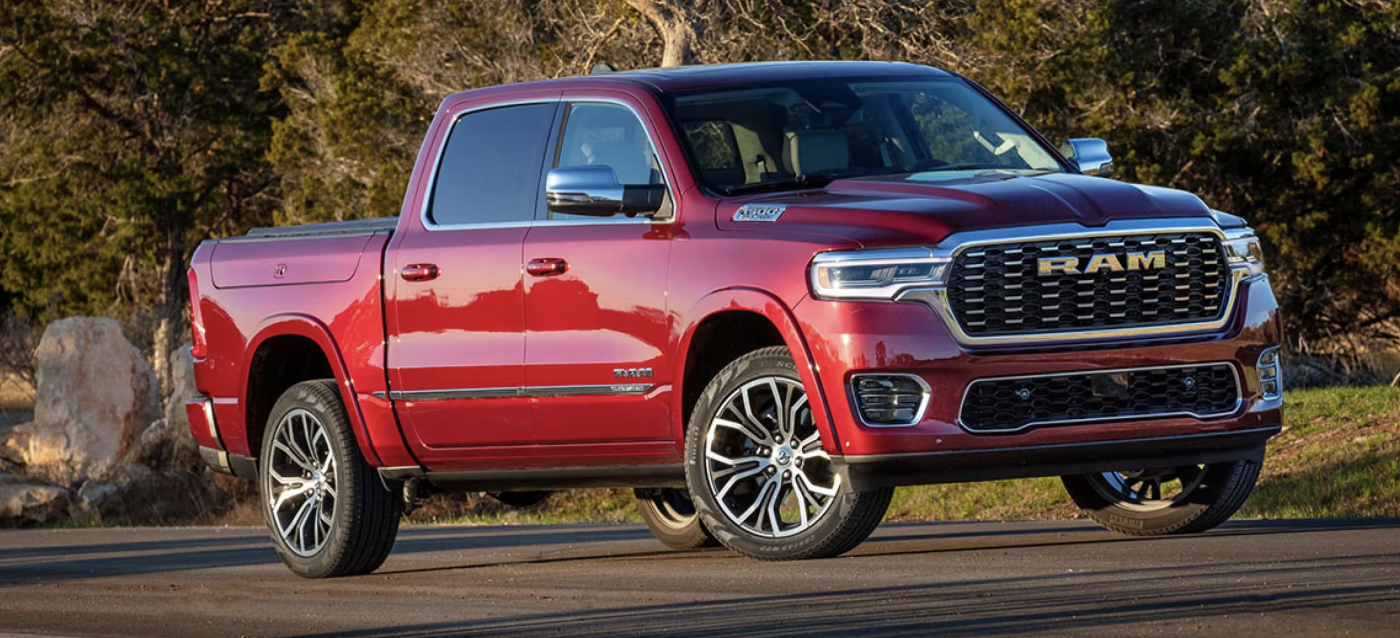 The red RAM 1500 is parked on the road