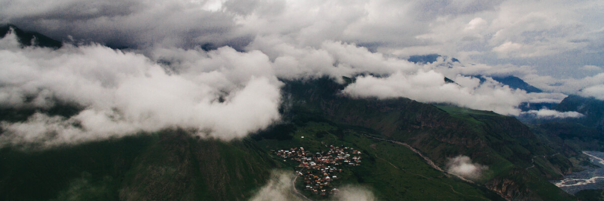 misty mountains with a town