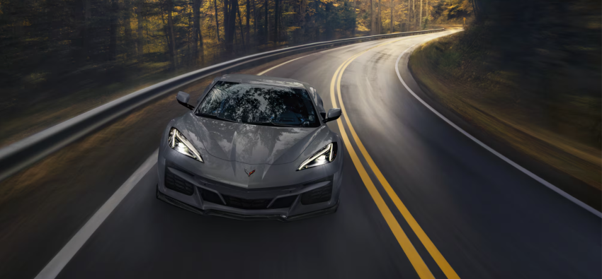 2025 Chevrolet Corvette E-Ray 2025 Chevrolet Corvette E-Ray driving down forest highway