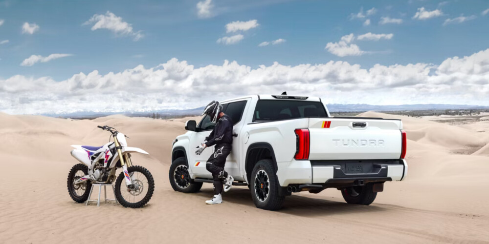 2026 Toyota Tundra in the desert with dirt bike rider