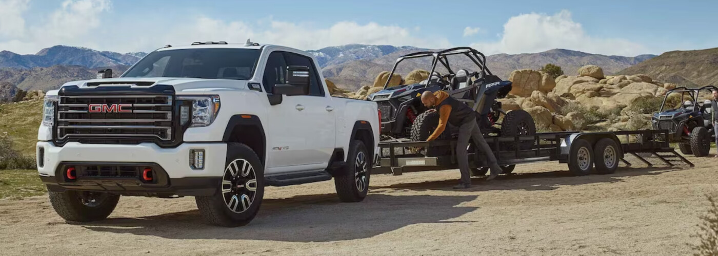 2023 GMC 3500 HD Towing a trailer in the desert