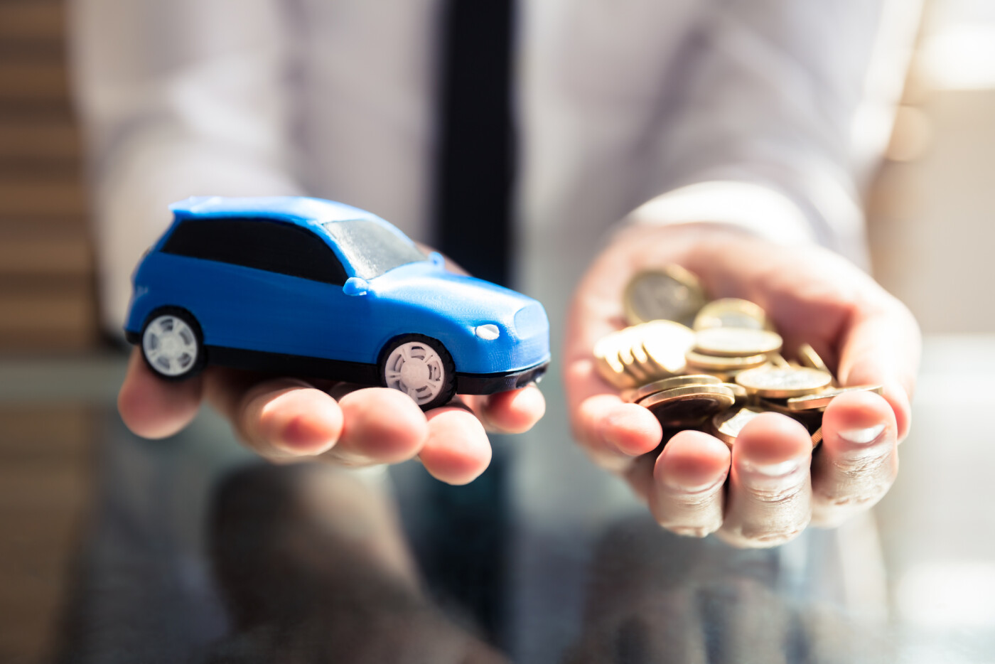 Hands Holding Car and Money