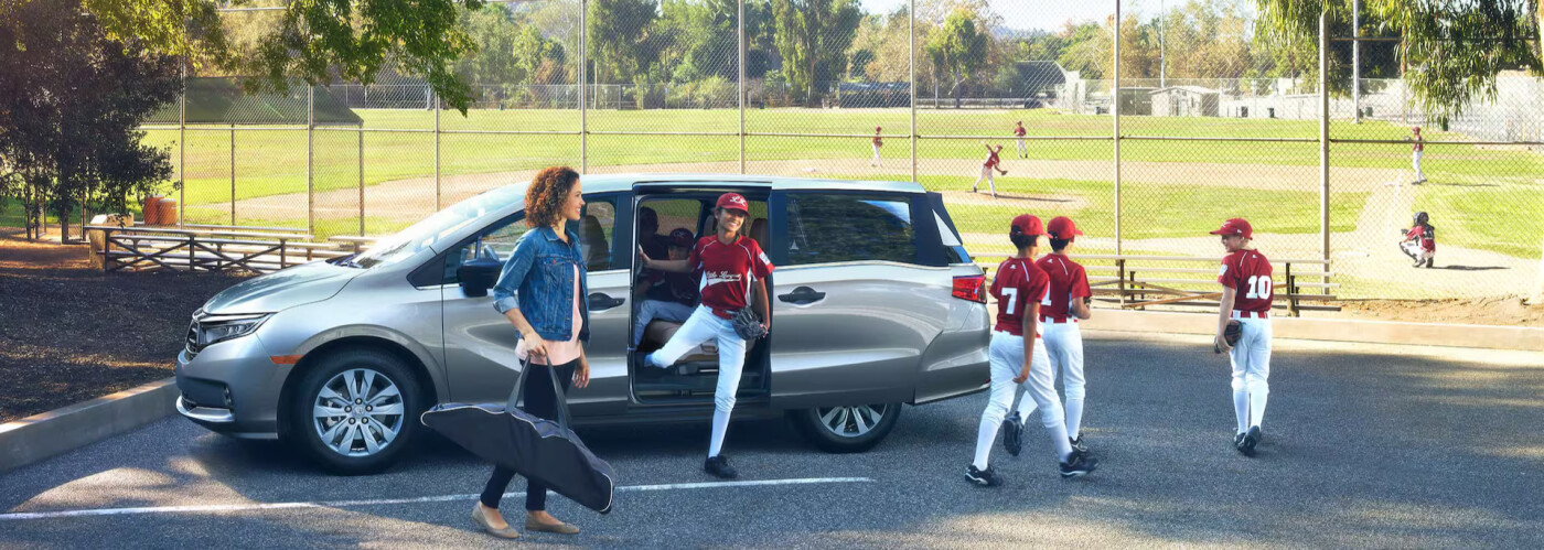 2024 Honda Odyssey parked by a baseball field 2024 Honda Odyssey parked by a baseball field