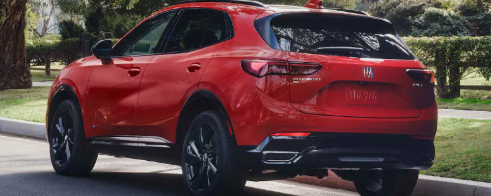 A red 2026 Buick Envision is parked along the curb. 