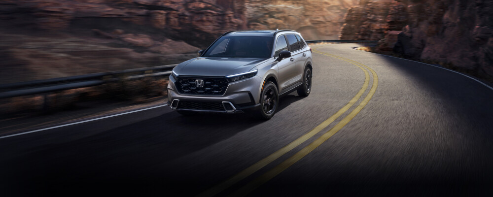 2025 Honda CR-V Hybrid driving on daytime mountain road