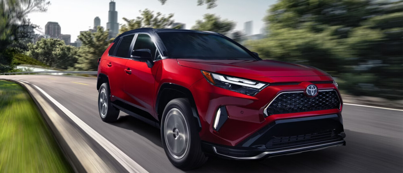 2026 Red Toyota RAV4 hybrid driving fast