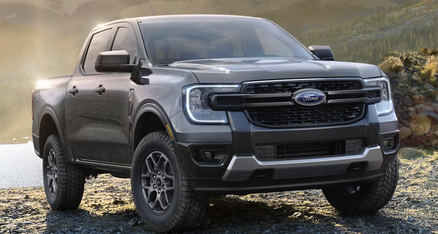 A gray Ford Ranger is parked near a lake.