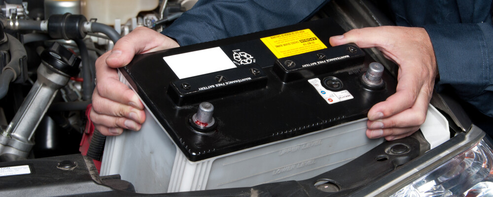 Auto Mechanic Replacing Car Battery
