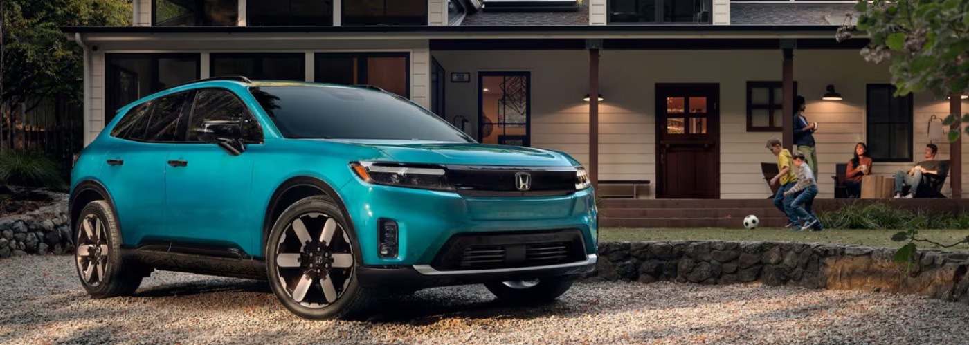 2026 Honda Prologue parked in front of house with family spending time outside