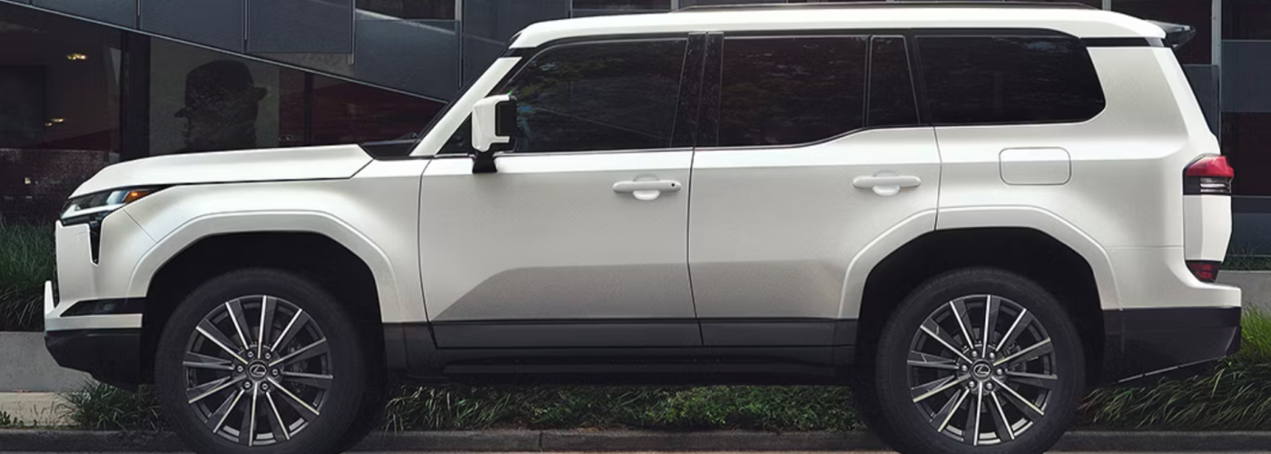 A white Lexus GX is parked on the street.