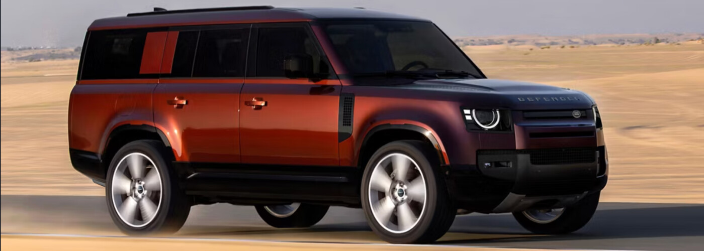 2026 Land Rover Defender driving through sand outside