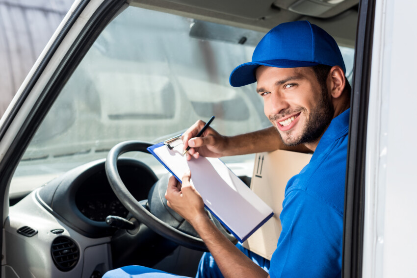 Delivery person is signing paperwork.
