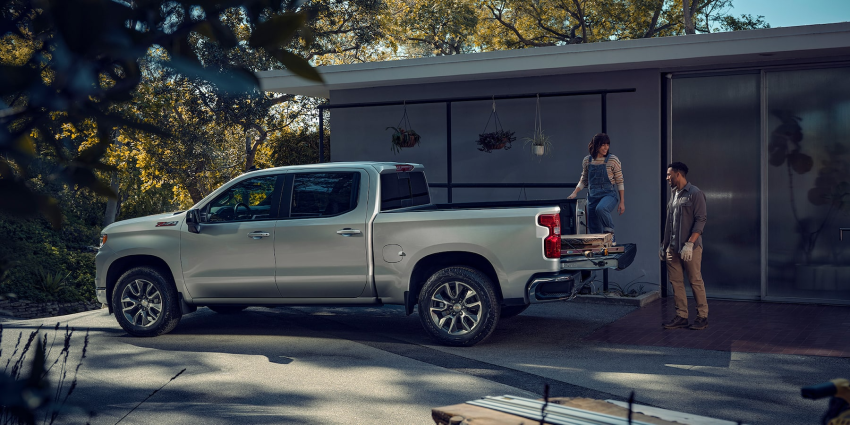 2023 Chevrolet Silverado 1500 person loading wood onto truck's bed