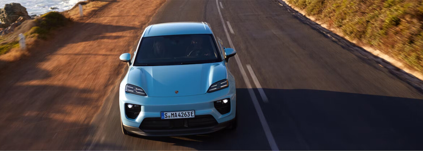 Porsche Macan Electric driving down road