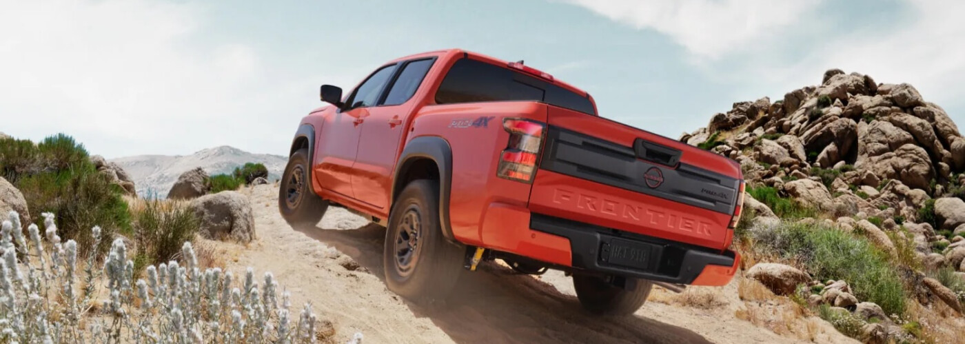 2026 Orange Nissan Frontier climbing hill