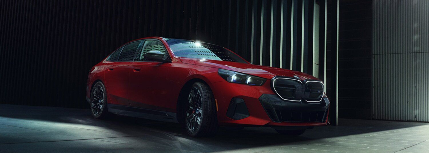 Red 2026 BMW emerging from the shadows