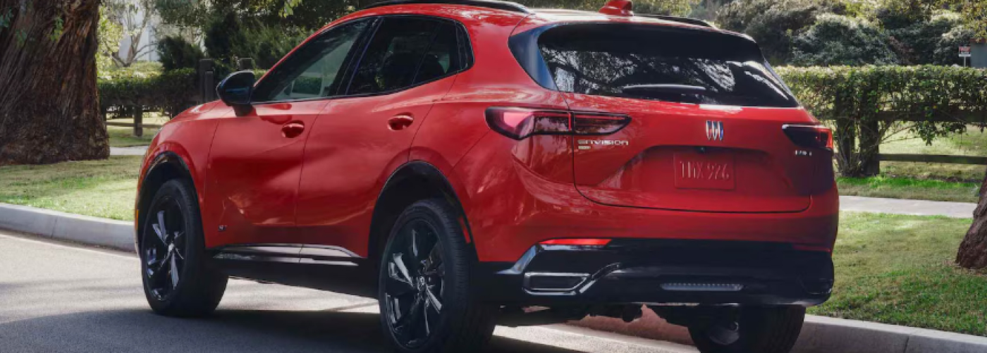 A red 2026 Buick Envision is parked along the curb. 
