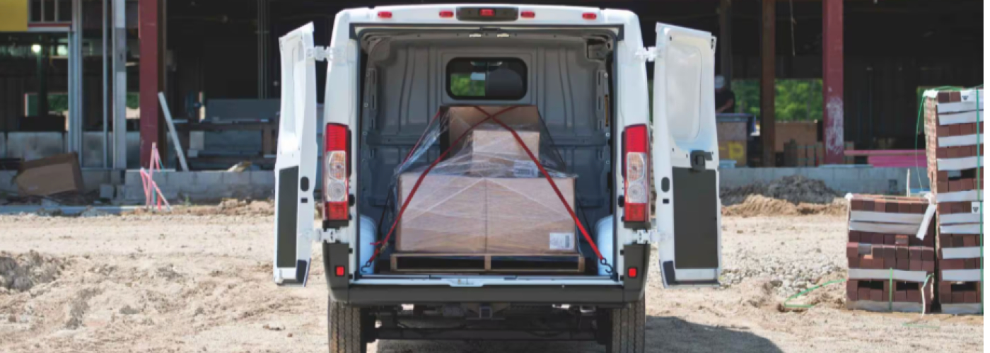 The white van has cargo that is strapped down for safety purposes.
