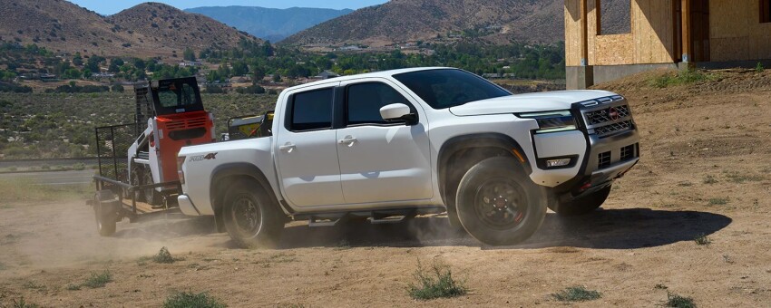 2026 White Nissan Frontier towing 