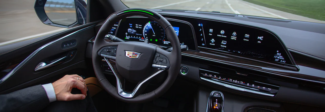 DRIVER ASSISTANCE, Cadillac Super Cruise button on steering wheel, man in cadillac using super cruise 