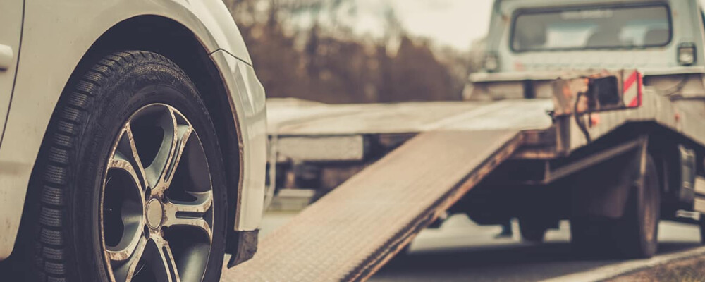 Roadside assistance tow truck loading car