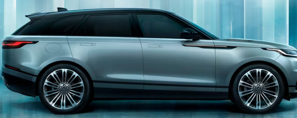 2026 Range Rover Velar The turquoise colored suv is in front of a colorful wall.