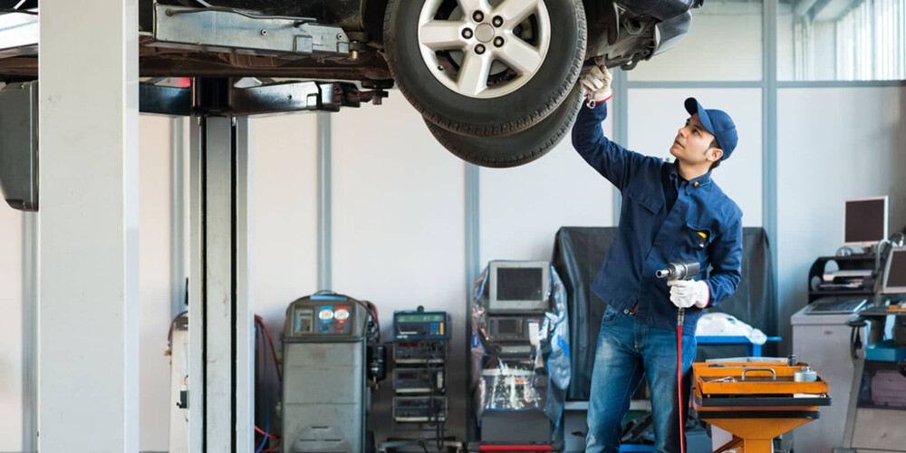 Service Technician Working Under Vehicle Service Technician Working Under Vehicle