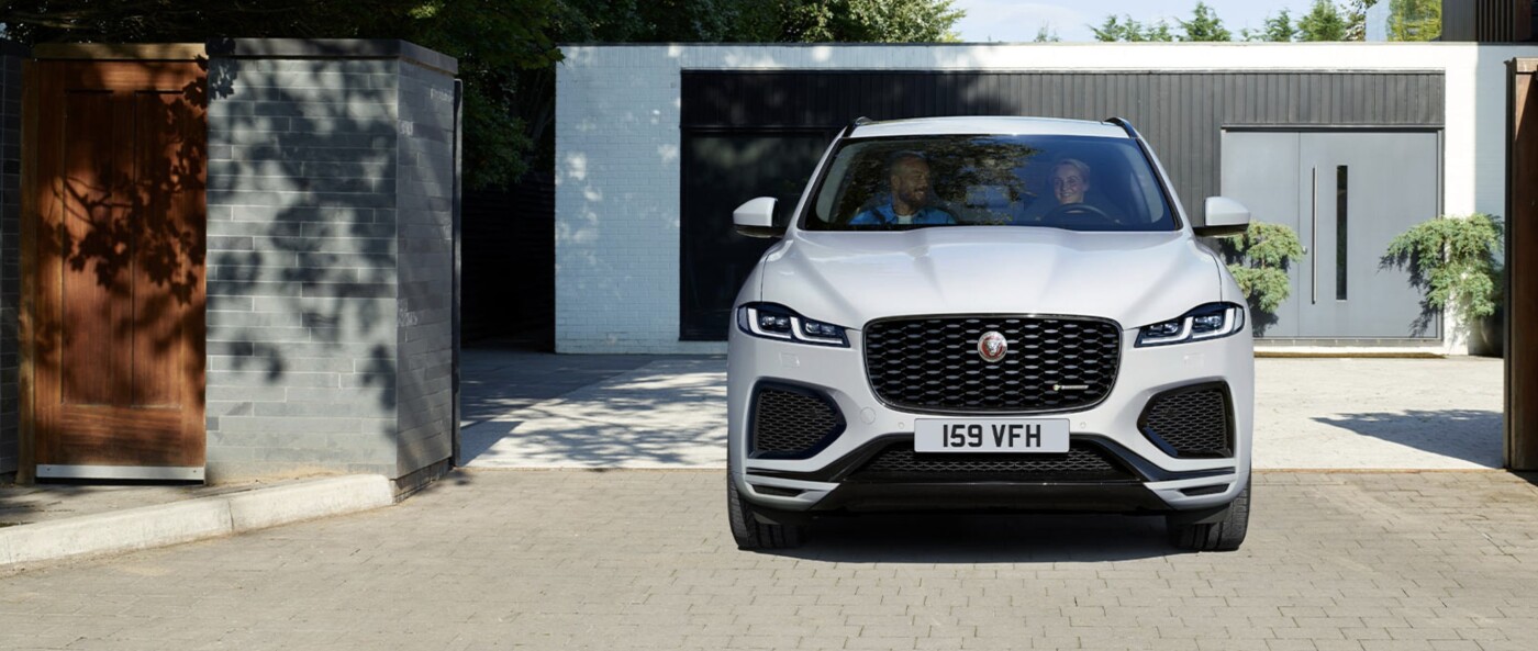 Couple sitting inside parked 2022 Jaguar F-PACE Couple sitting inside parked 2022 Jaguar F-PACE