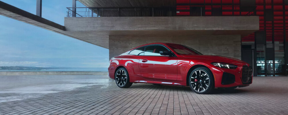 red 2026 BMW 4 Series parked on brick garge
