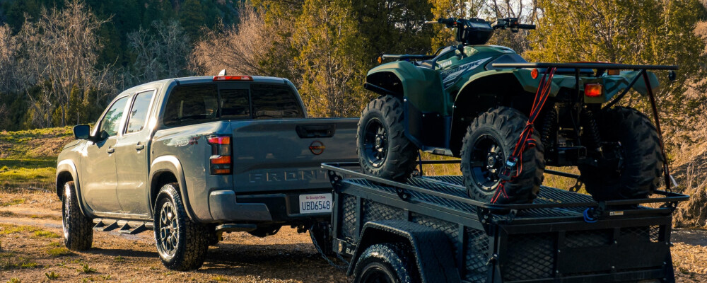 2023 Nissan Frontier Crew Cab Pro-4X with Premium Package Towing a Four Wheeler