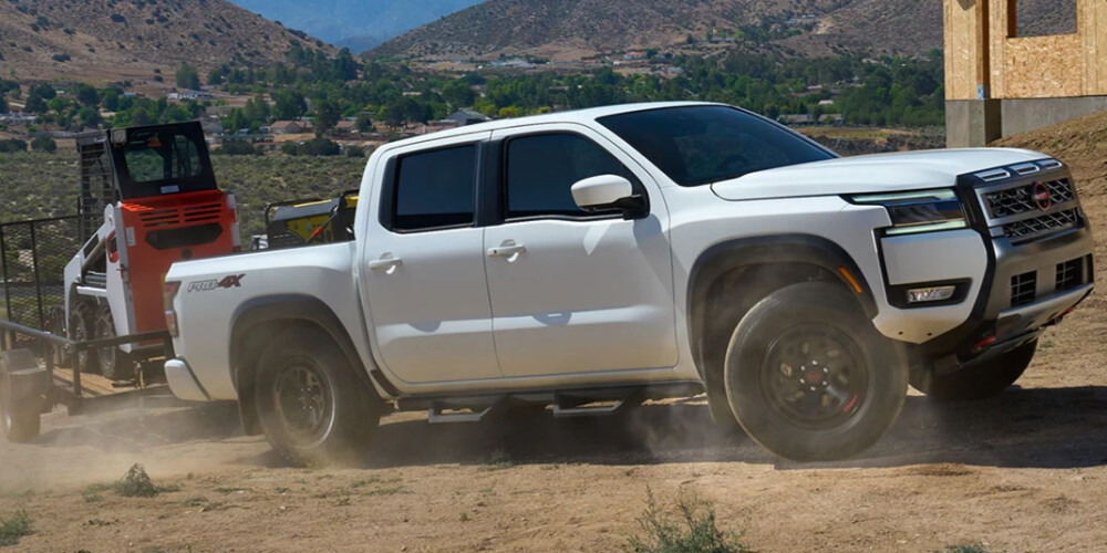 2026 White Nissan Frontier towing 