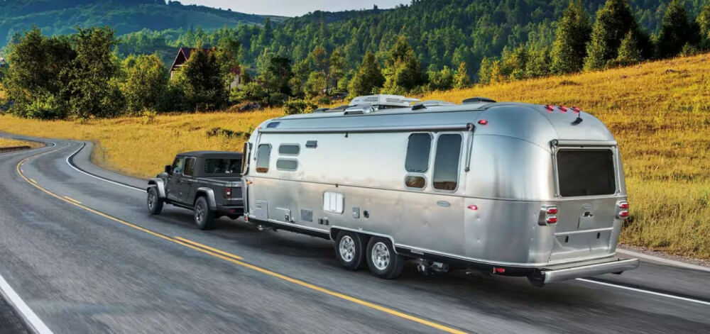2026 Jeep Gladiator towing airstream on road