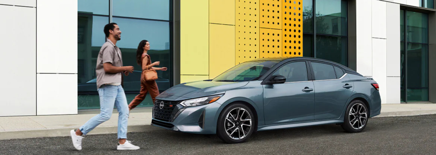 2024 Nissan Sentra parked with a couple approaching the car