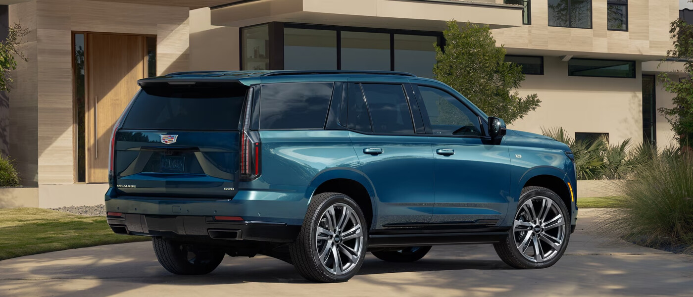 Blue 2026 Cadillac ESCALADE parked in front of house