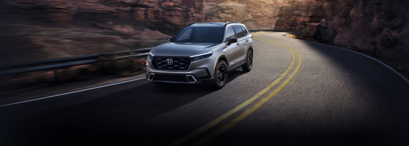 2025 Honda CR-V Hybrid driving on daytime mountain road