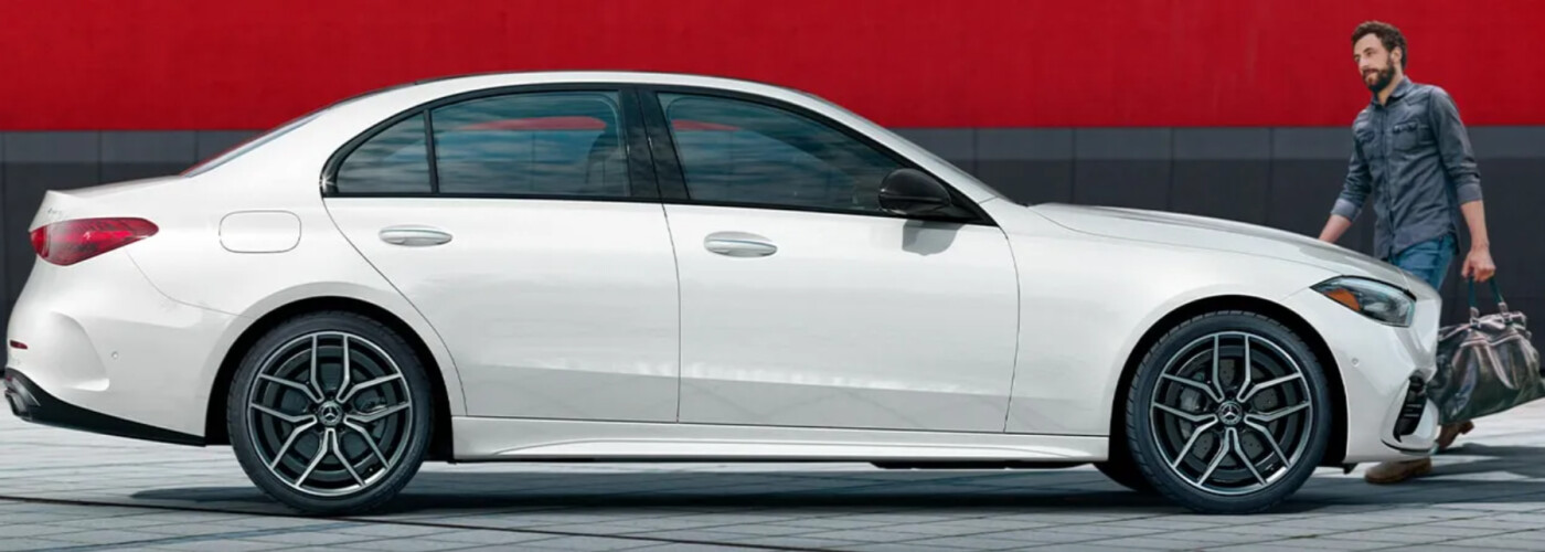 white 2025 Mercedes-Benz C 300 with man and luggage